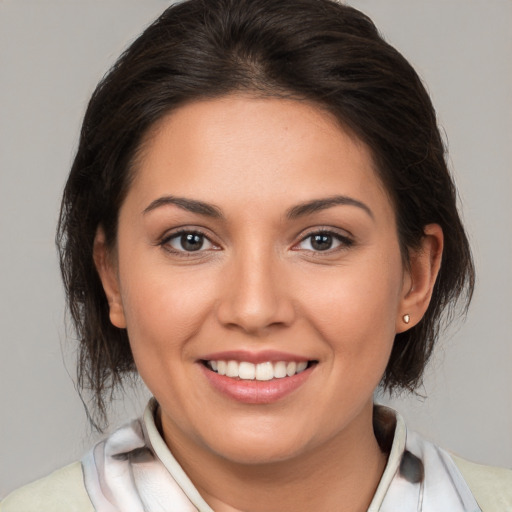 Joyful white young-adult female with medium  brown hair and brown eyes