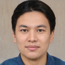 Joyful asian young-adult male with short  black hair and brown eyes