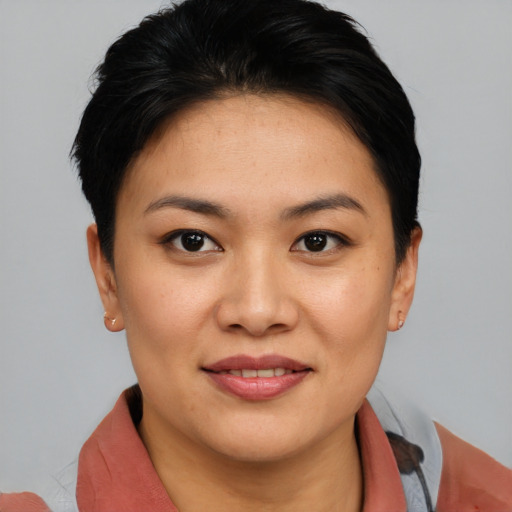 Joyful asian young-adult female with short  brown hair and brown eyes