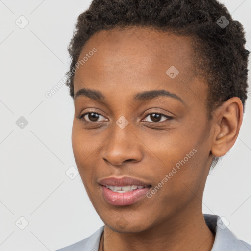 Joyful black young-adult female with short  brown hair and brown eyes