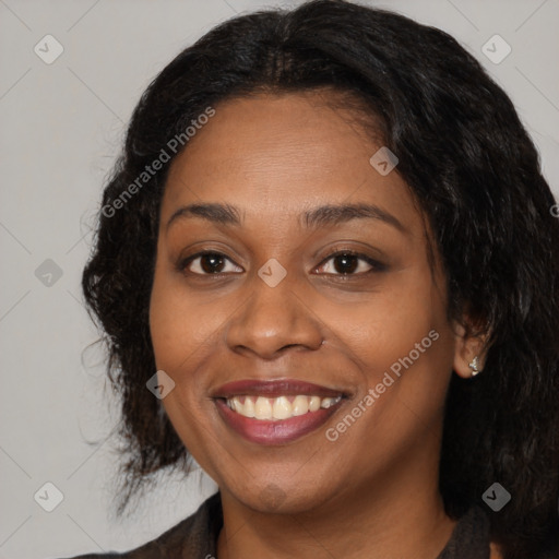 Joyful black young-adult female with long  brown hair and brown eyes