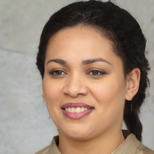 Joyful latino young-adult female with medium  brown hair and brown eyes