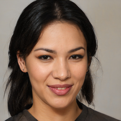 Joyful latino young-adult female with medium  brown hair and brown eyes