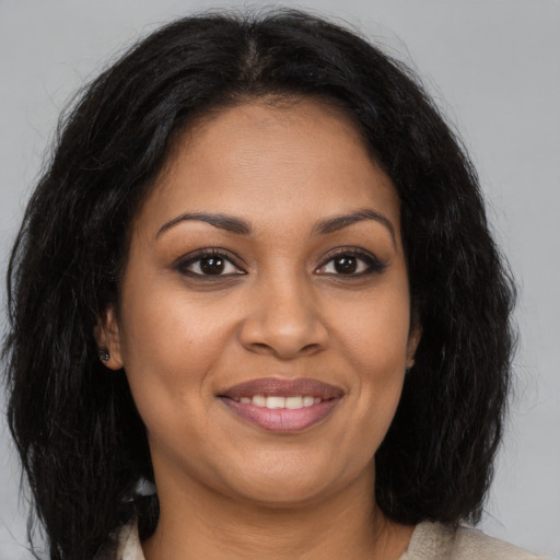 Joyful black young-adult female with medium  brown hair and brown eyes