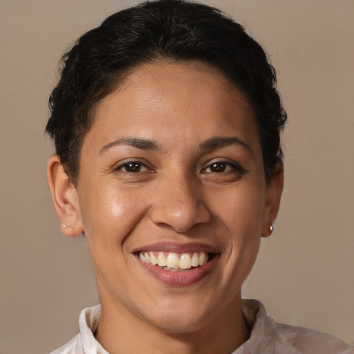 Joyful latino young-adult female with short  brown hair and brown eyes