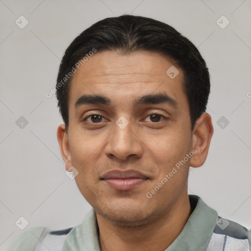 Joyful latino young-adult male with short  black hair and brown eyes