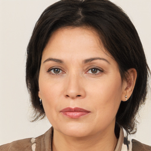 Joyful white adult female with medium  brown hair and brown eyes