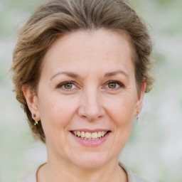 Joyful white adult female with medium  brown hair and grey eyes