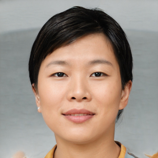 Joyful asian young-adult female with short  black hair and brown eyes