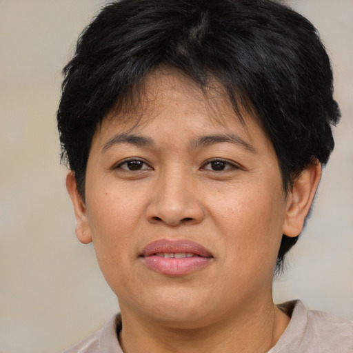 Joyful asian young-adult female with short  brown hair and brown eyes