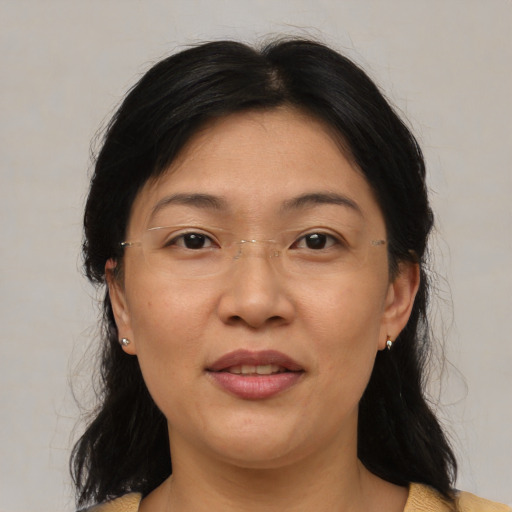 Joyful asian adult female with medium  black hair and brown eyes