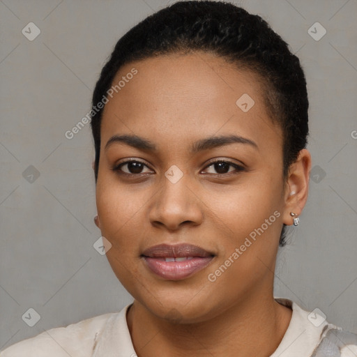 Joyful black young-adult female with short  black hair and brown eyes