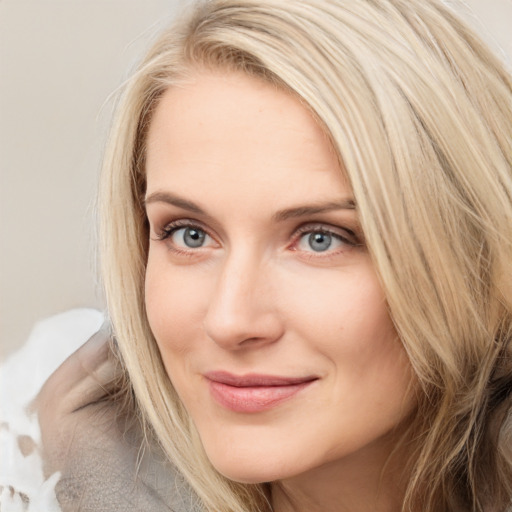 Joyful white young-adult female with long  brown hair and blue eyes