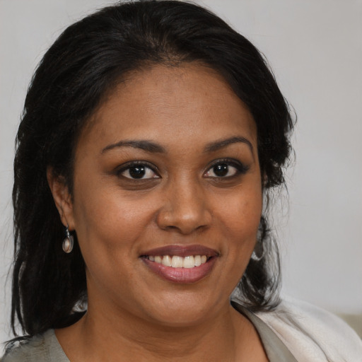 Joyful black young-adult female with medium  brown hair and brown eyes