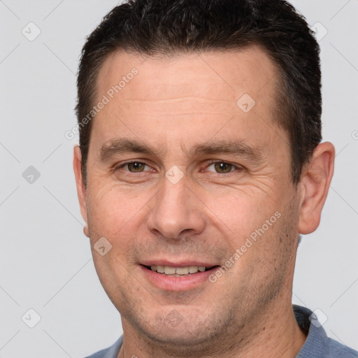 Joyful white adult male with short  brown hair and brown eyes