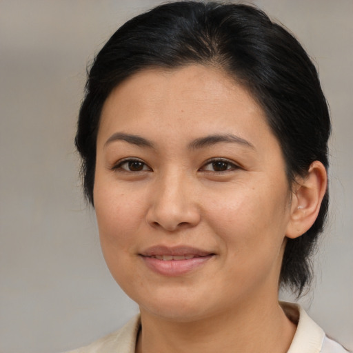 Joyful asian young-adult female with medium  brown hair and brown eyes