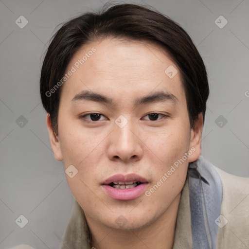 Joyful asian young-adult male with short  brown hair and brown eyes