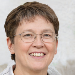 Joyful white middle-aged female with short  brown hair and grey eyes