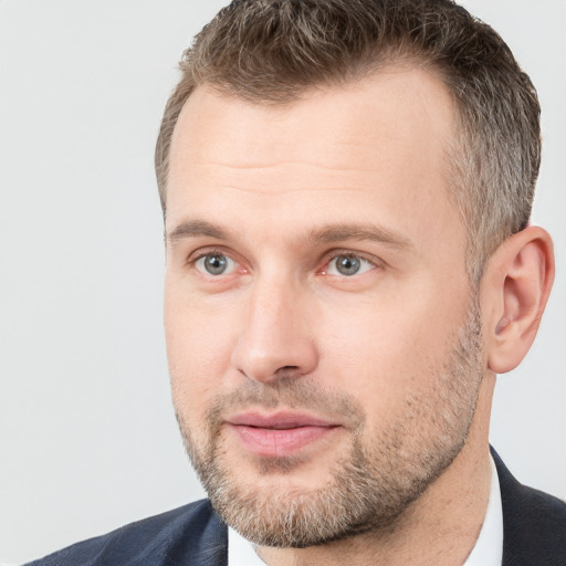 Joyful white adult male with short  brown hair and brown eyes