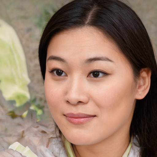 Joyful asian young-adult female with medium  brown hair and brown eyes