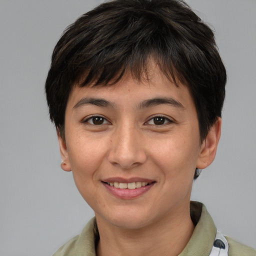 Joyful asian young-adult female with short  brown hair and brown eyes