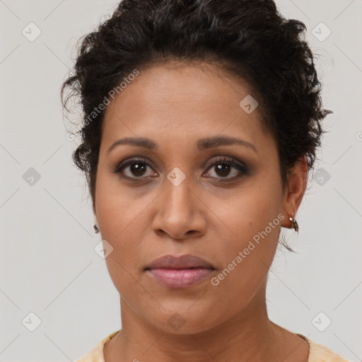 Joyful black young-adult female with short  brown hair and brown eyes