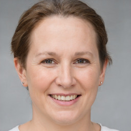 Joyful white adult female with short  brown hair and grey eyes