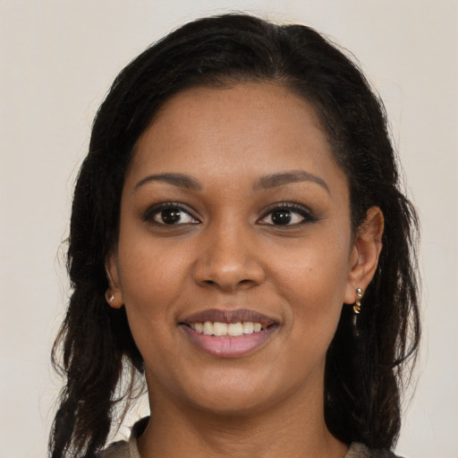 Joyful black young-adult female with medium  brown hair and brown eyes