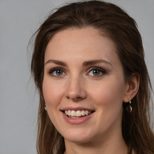 Joyful white young-adult female with long  brown hair and grey eyes