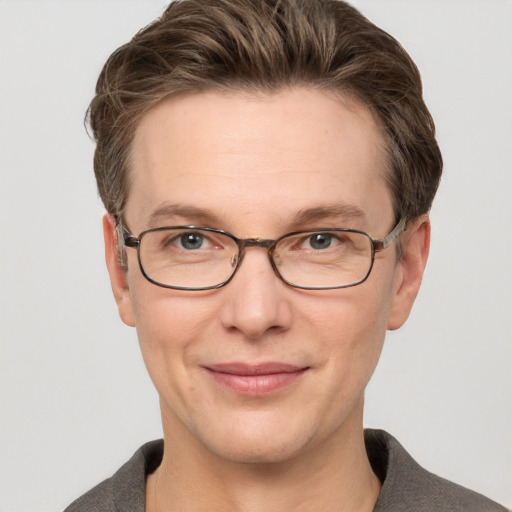 Joyful white adult male with short  brown hair and grey eyes