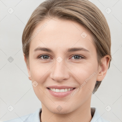 Joyful white young-adult female with short  brown hair and grey eyes