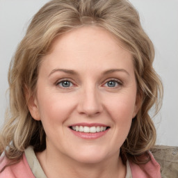 Joyful white young-adult female with medium  brown hair and blue eyes