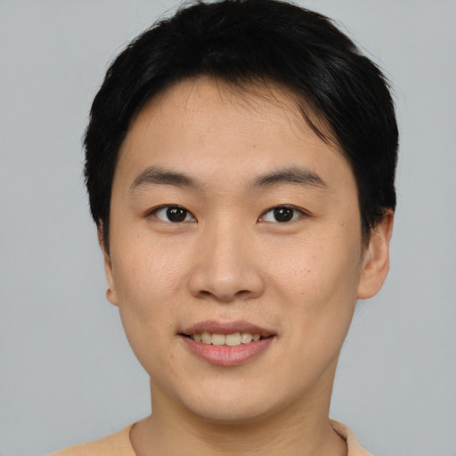 Joyful asian young-adult female with short  black hair and brown eyes