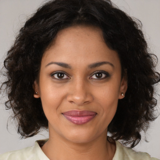 Joyful black young-adult female with medium  brown hair and brown eyes