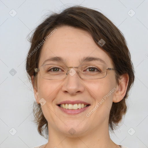 Joyful white adult female with medium  brown hair and green eyes