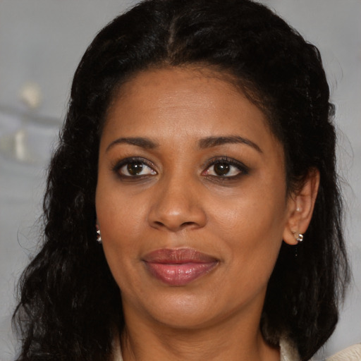Joyful black young-adult female with medium  brown hair and brown eyes