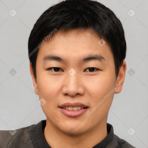 Joyful asian young-adult male with short  black hair and brown eyes