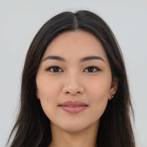 Joyful asian young-adult female with long  brown hair and brown eyes