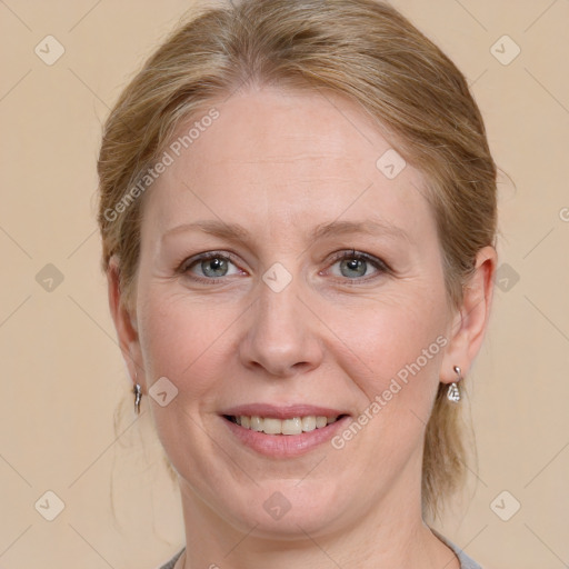 Joyful white adult female with medium  brown hair and blue eyes