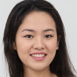 Joyful asian young-adult female with long  brown hair and brown eyes