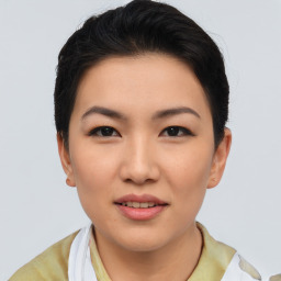 Joyful asian young-adult female with short  brown hair and brown eyes