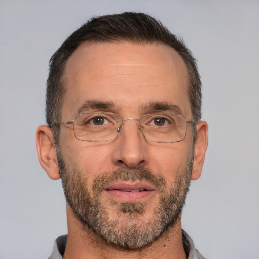 Joyful white adult male with short  brown hair and brown eyes