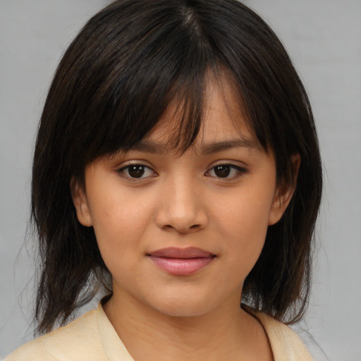 Joyful asian child female with medium  brown hair and brown eyes