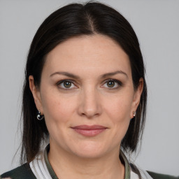 Joyful white adult female with medium  brown hair and grey eyes