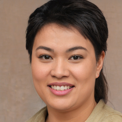 Joyful asian young-adult female with medium  brown hair and brown eyes