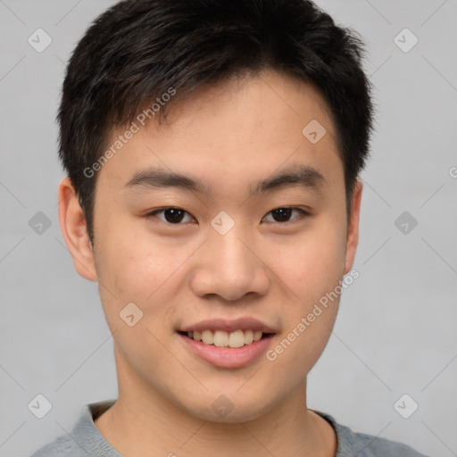 Joyful asian young-adult male with short  brown hair and brown eyes