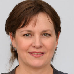 Joyful white adult female with medium  brown hair and grey eyes