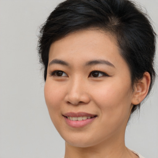Joyful asian young-adult female with medium  brown hair and brown eyes