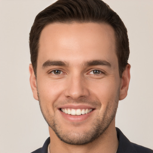 Joyful white young-adult male with short  brown hair and brown eyes