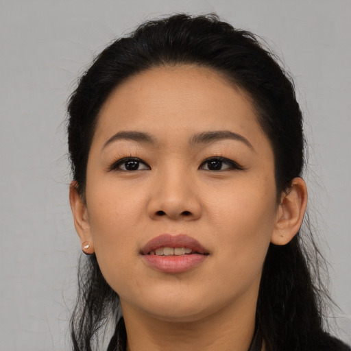 Joyful asian young-adult female with long  black hair and brown eyes